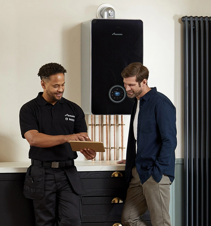 Engineer diagnosing a boiler fault with the homeowner in Egham