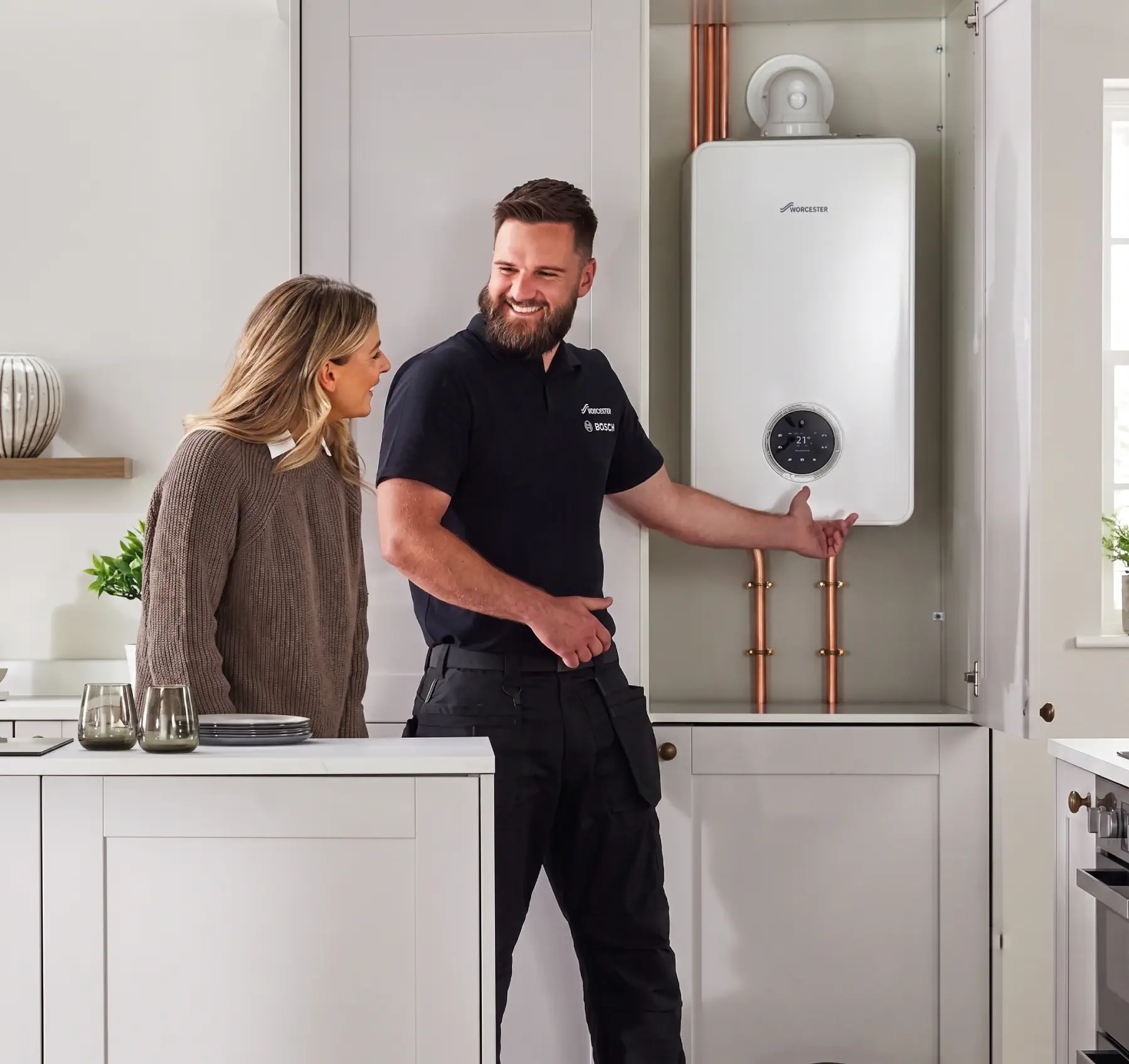 Engineer talking a homeowner through a newly fitted combi boiler in Egham